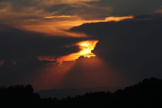 Sunset in stormy clouds over The Swiss alps, Dramatic sunset