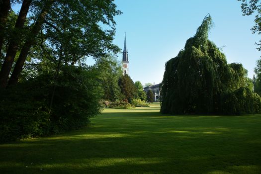 pictures of the city of Zug, Switzerland. trees, grass and blue sky