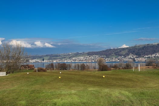 Gold Course over the lake Zug, calm scene in park in Zug, Switzerland