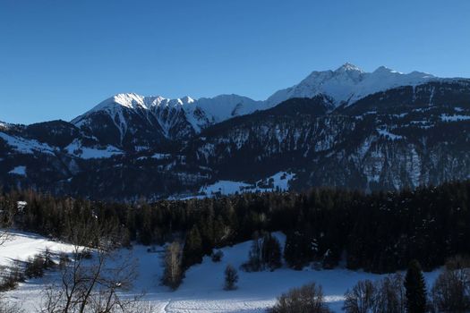 Mountains in winter at Laax ski resort, during twilight