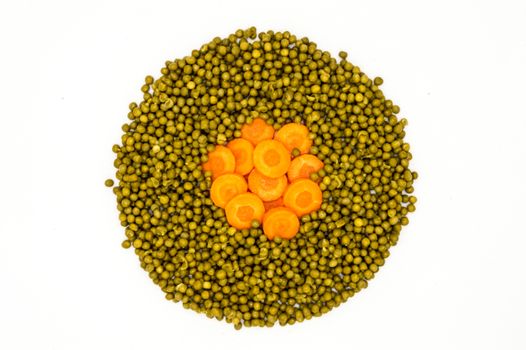 Circle of peas and carrot rings on a white background