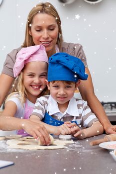 Mother helping her children baking with twinkling stars