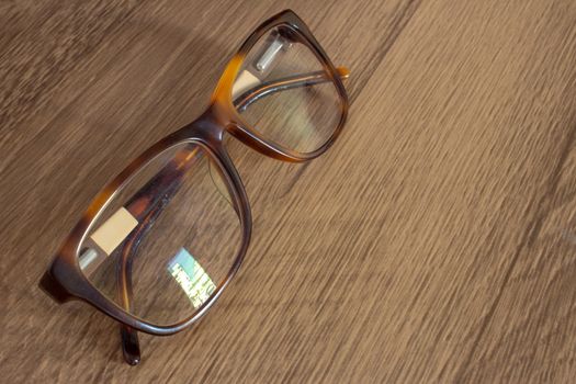 Closeup on a par of glasses on top of a wooden table