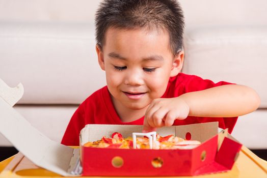 Hot Homemade, Vegetarian fast Italian food, Cute Little Child enjoying holding Delivery Pizza pepperoni, cheese many slices in an open cardboard box at home