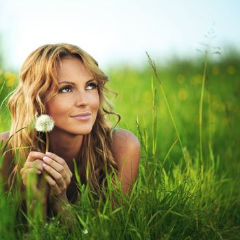 Girl with dandelion on spring meadow i wish concept