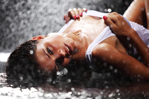 sexy young woman posing in water studio