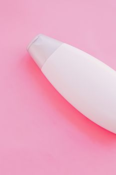 Blank label shampoo bottle or shower gel on pink background, beauty product and body care cosmetics, flatlay