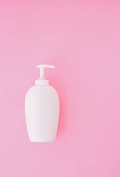 Bottle of antibacterial liquid soap and hand sanitizer on pink background, hygiene product and healthcare, flatlay