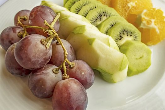 ready to eat sliced mixed fruits in plate