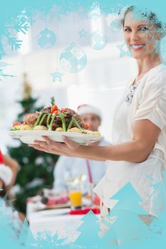 Attractive woman bringing roast chicken at a christmas dinner against christmas frame