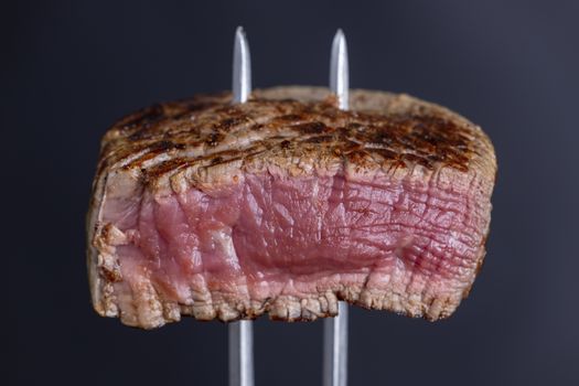 grilled steak on a meat fork