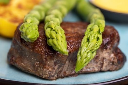 asparagus with potatoes and a steak