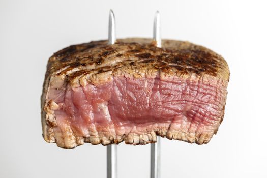 grilled steak on a meat fork