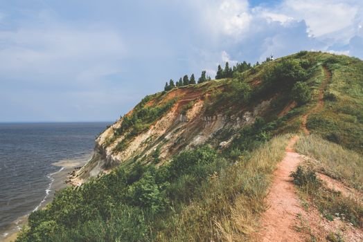 Hiking trail on mountainside at summer cloudy day