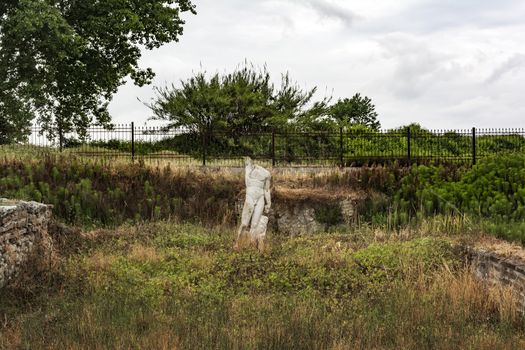 Ancient ruins and sculpture in Dion site, Greece.