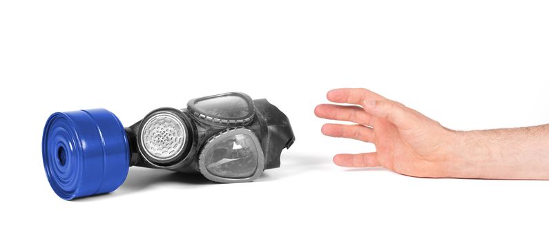 Arm reaching for vintage gasmask isolated on a white background - Blue filter