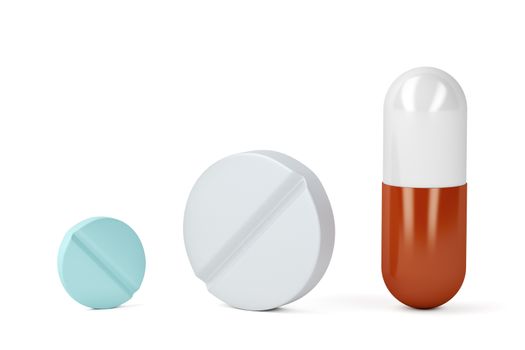 Pills and a capsule on white background