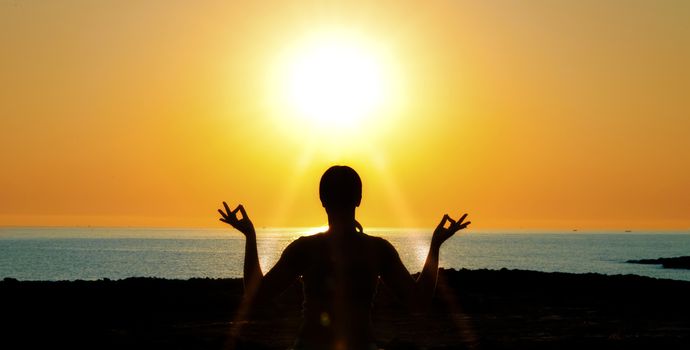 woman silhouette in the sun light on sea