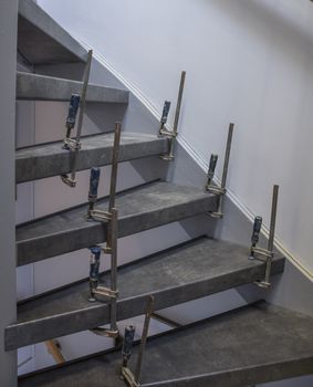 glue clamps during stairs renovation with wall background