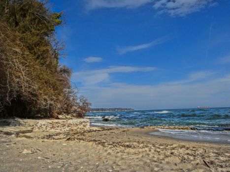 The favorite summer landscape containing golden sands and blue waves on a secret beach.