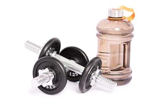 Close up shot of two stainless steel dumbbells and a large water bottle for the gym, isolated on a white background. Healthy lifestyle and fitness concept. Copy space.