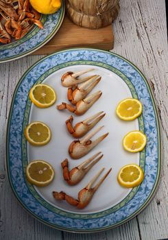 Cooked fiddler crab claws and lemon wedges. Typical Andalusian dish