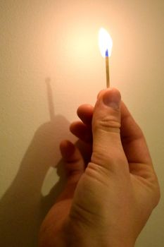 Holding a lit match showing that fire has no shadow