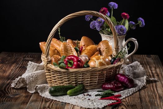 Pies with meat in the wicker basket on a black background