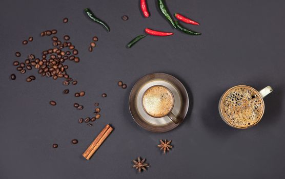 Cup of coffee and pepper on a black background