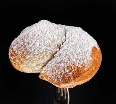 Pie on a fork on a black studio background