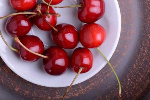 Fresh cherry on wooden plate. fresh ripe cherries. Top view. sweet cherries.
