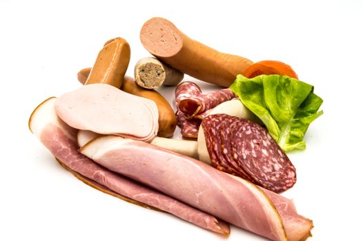 Assortment of delicious cold meats on a white background