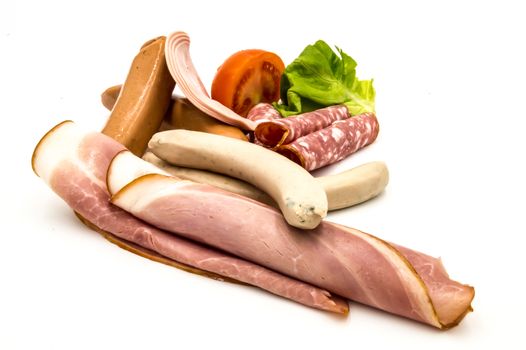 Different kinds of sausage and smoked bacon, on a white background