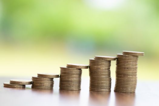 Pile of coins arranged in order from low to high Placed on the table.Money saving concept. Financial concepts Business planning and growth.