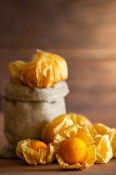 Cape gooseberry in burlap bags. Concept of health care or herb. Closeup and copy space for text.