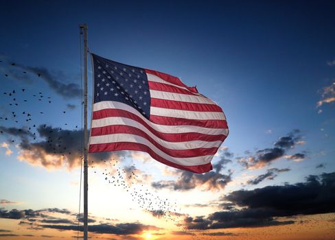 An American flag blowing in the wind with nice sky and jet stream in the background