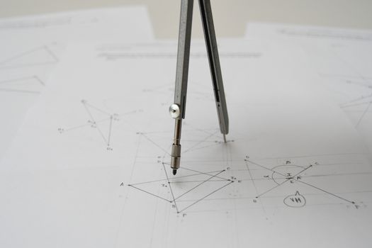 Technical drawing with drafting compass, papers