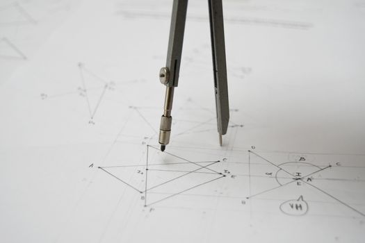 Technical drawing with drafting compass, papers