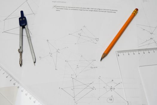 Technical drawing table with pencil, drafting compass, rulers, papers
