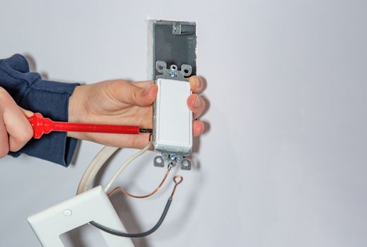 Attaching a white platband to an electrical wall outlet