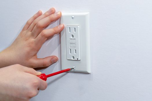 Attaching a white platband to an electrical wall outlet