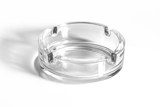 A glass ash tray on white background with shadow