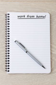 A work from home note on pad with pen