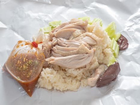 The close up of Thai chicken rice food on paper sheet.