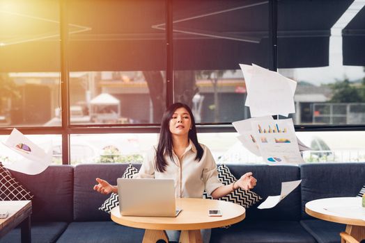 Lifestyle freelance business woman and laptop computer he has throwing document after success the job in coffee shop