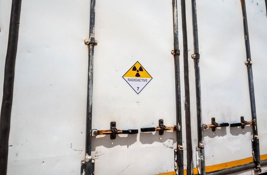 Radiation warning sign on the Hazardous materials transport label Class 7 at the aluminum container of transport truck