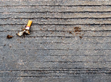 The cigarette butt let down on the concrete floor