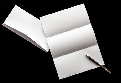 blank of letter paper and white envelope with pen Isolated on black background