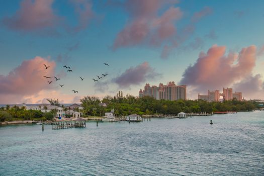 Home on a finger of land in the Bahamas with a pink resort in the background