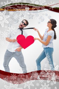 Brunette pulling her boyfriend by the tie against christmas frame